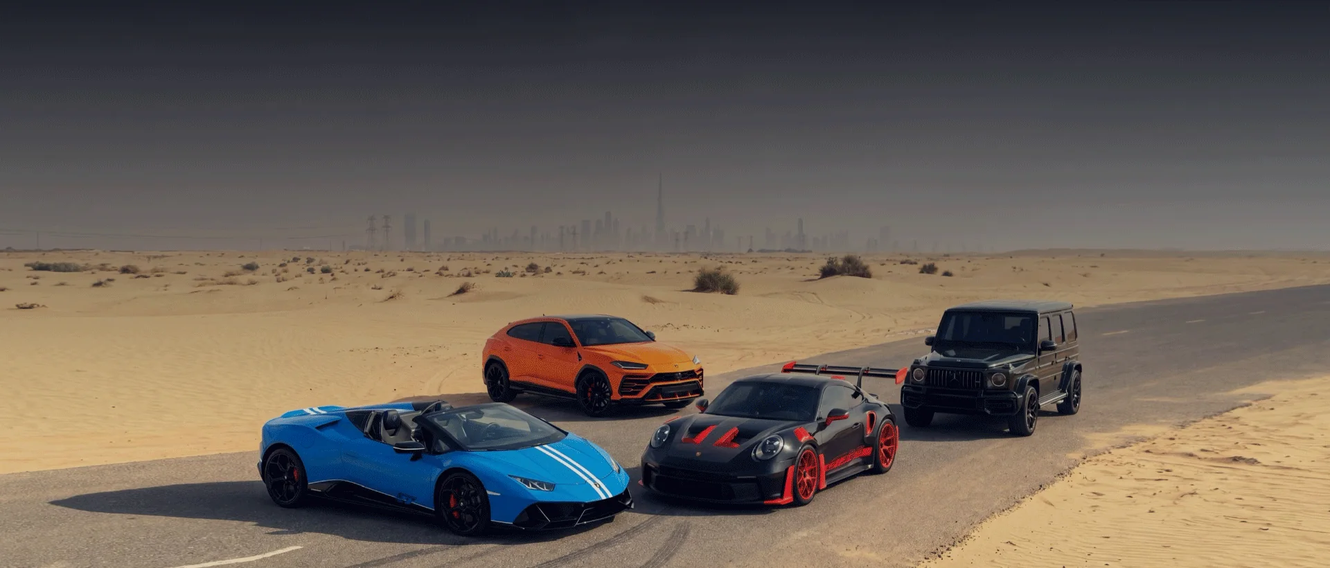 GulfRides luxury and performance rental fleet photographed in the Dubai desert